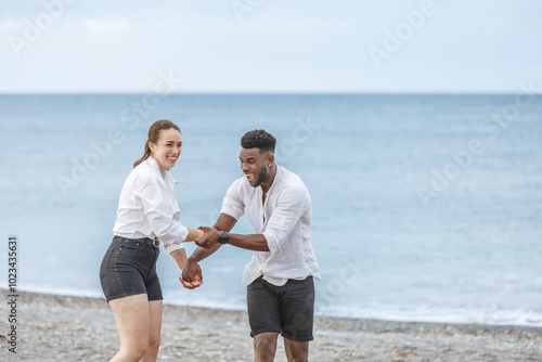 Joyful moments at Playa del Zapillo in Almeria, Spain, as a couple enjoys playful interaction by the serene beach photo