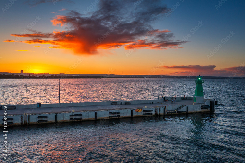 Green lighthouse on the western breakwater in Nowy Port at sunset, Gdansk. Green lighthouse on the western breakwater in Nowy Port at sunset, Gdansk.