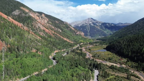 High alpine mountain view near Silverton, Colorado. Featured are the rich, red rock of the mountains as the flight goes down the valley.