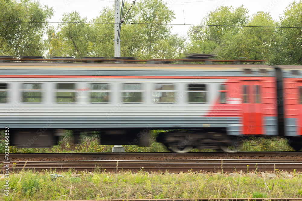 Fototapeta premium departing passenger train in motion with blur effect