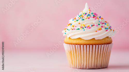 Delicious cupcake with frosting and colorful sprinkles on a pastel pink background. Perfect for sweet treats, dessert menus, or party celebrations. photo