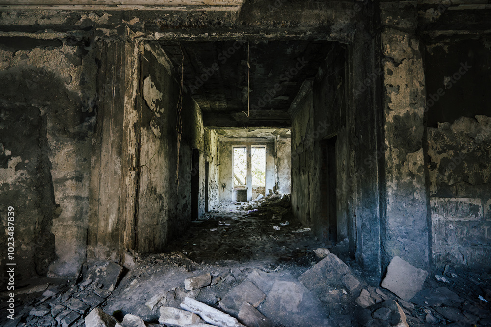 Abandoned corridor in dilapidated building with crumbling walls and debris scattered across the floor. Light from broken windows contrasts with dark, eerie interior, creating a sense of decay and Abandoned corridor in dilapidated building with crumbling walls and debris scattered across the floor. Light from broken windows contrasts with dark, eerie interior, creating a sense of decay and