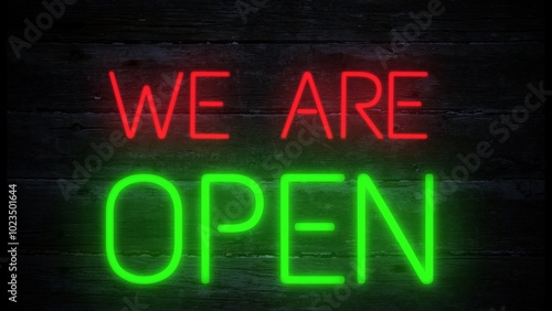 We are open neon effect sign on a dark wooden background