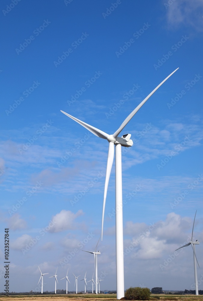 wind turbine with three blades rotating using wind power to produce electricity with zero environmental impact anc blue sky wind turbine with three blades rotating using wind power to produce electricity with zero environmental impact anc blue sky