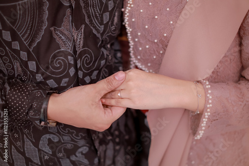 Close up of couple's hands holding each other. Indonesian proposal procession. Illustration of love