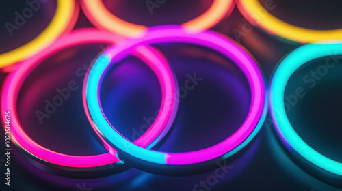 Dynamic interlocking rings of light in bright neon colors create vibrant visual effect. glowing hues of pink, blue, and yellow evoke sense of energy and excitement