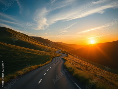 Road through the mountains at sunset with vibrant sky