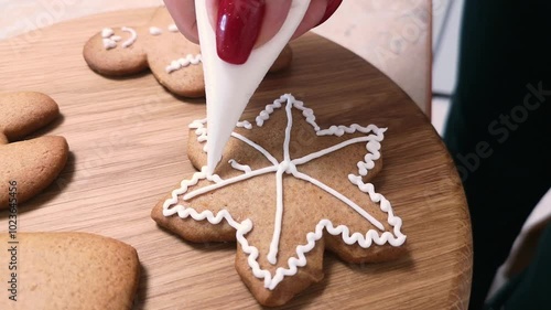 Christmas gingerbread. Decorating gingerbread cookies for Christmas. Family Christmas and New Year traditions. Close-up.