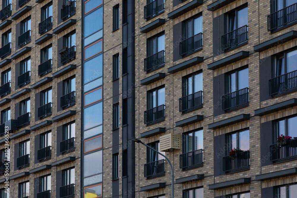 Modern high-rise apartment buildings in a residential area showcasing diverse window styles and balcony designs Modern high-rise apartment buildings in a residential area showcasing diverse window styles and balcony designs
