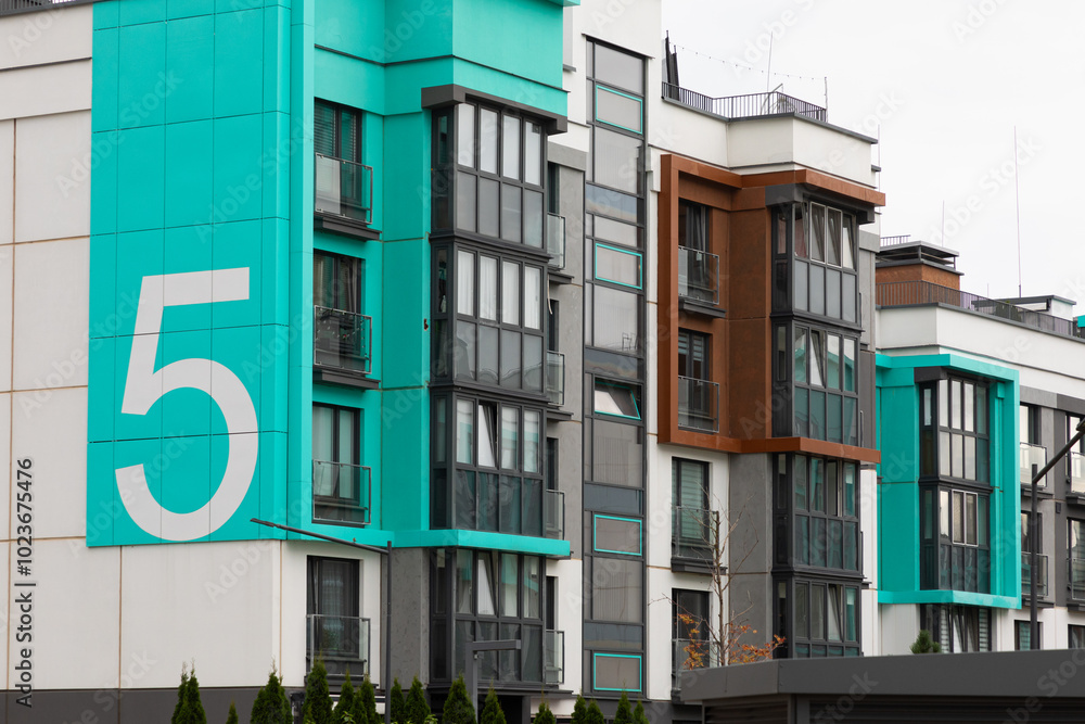 Modern high-rise apartment buildings with distinctive blue accents in a residential area highlighting urban living trends Modern high-rise apartment buildings with distinctive blue accents in a residential area highlighting urban living trends