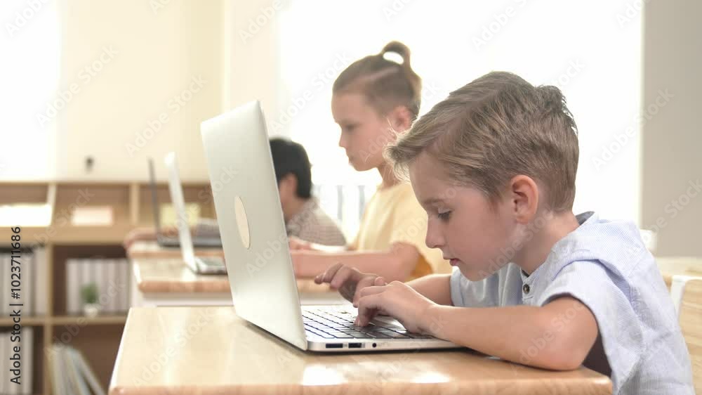 Caucasian smart child programing software system and learning about coding while multicultural searching about engineering code. Happy boy thinking about engineering prompt by using laptop. Pedagogy. Caucasian smart child programing software system and learning about coding while multicultural searching about engineering code. Happy boy thinking about engineering prompt by using laptop. Pedagogy.