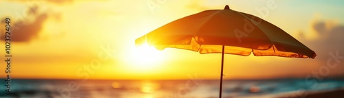 A vibrant beach umbrella at sunset, casting a silhouette against a colorful sky. photo