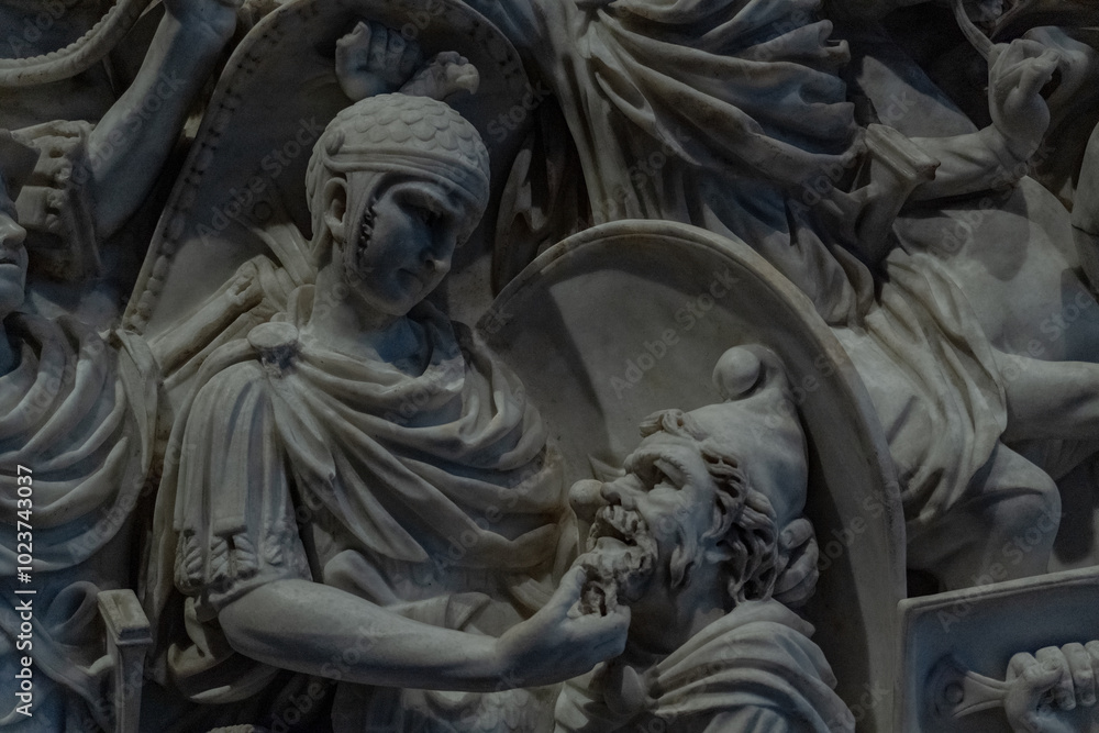 A statue of a man biting another man's head A statue of a man biting another man's head