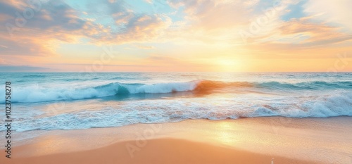 Serene beach sunset with soft waves and colorful sky. 