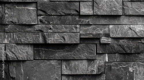 Dark textured stone wall with irregular brick pattern.
