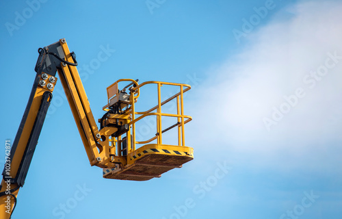 Wallpaper Mural A bright yellow lift stretches towards the sky during a clear day, ready for workers to reach great heights Torontodigital.ca
