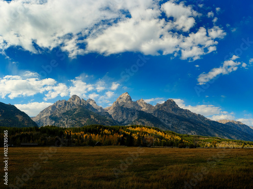 Grand Teton Mountains Tetons in Wyoming Rugged Mountain Range in Autumn Fall Landscape with blue sky and clouds