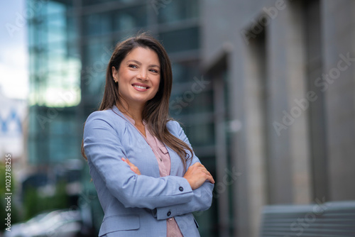 Portrait of business woman standing outdoor in blue suit