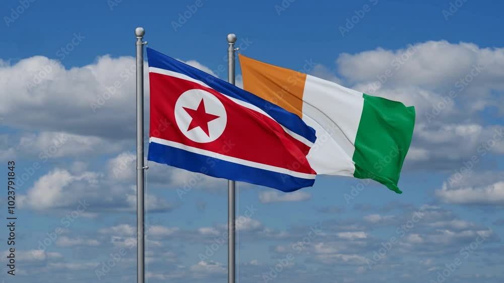 Ivory Coast or Cote d'Ivoire and North Korea flags flying together, video concept of the relationship, two country cooperation concept Ivory Coast or Cote d'Ivoire and North Korea flags flying together, video concept of the relationship, two country cooperation concept