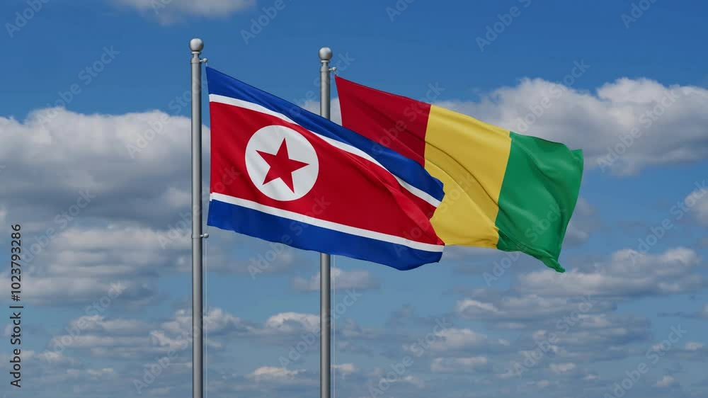 Republic of Guinea or Guinea-Conakry and North Korea flags flying together, video concept of the relationship, two country relations concept Republic of Guinea or Guinea-Conakry and North Korea flags flying together, video concept of the relationship, two country relations concept