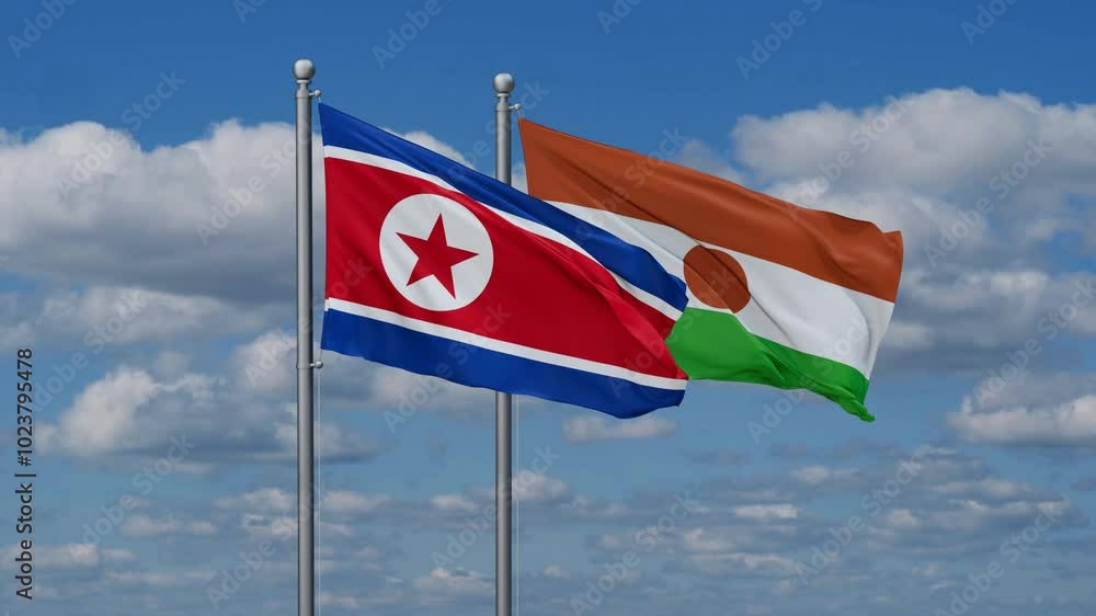 Niger and North Korea flags flying together, video concept of the relationship, two country relations concept Niger and North Korea flags flying together, video concept of the relationship, two country relations concept