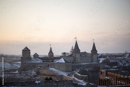 A wonderful historical castle at sunset in Ukraine. The city of Kamianets-Podilskyi. photo