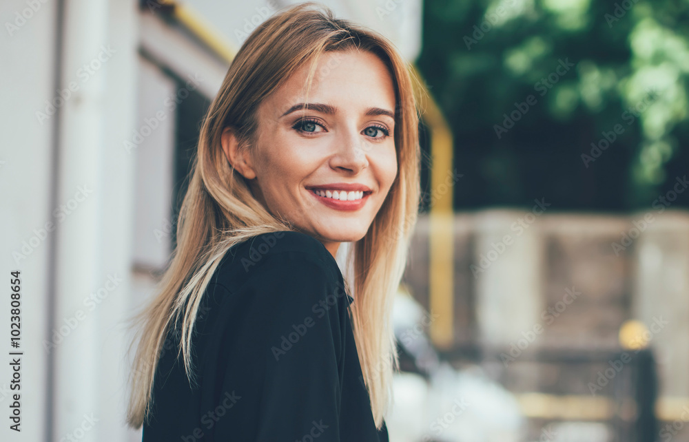 Concept of technology and generation, portrait of successful Caucasian female blogger dressed in casual shirt taking rest in street cafeteria holding digital gadget in hands and smiling at camera Concept of technology and generation, portrait of successful Caucasian female blogger dressed in casual shirt taking rest in street cafeteria holding digital gadget in hands and smiling at camera