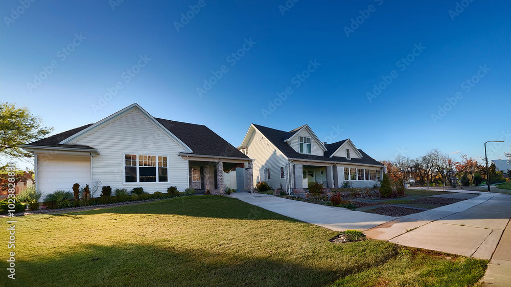 Single story single family upscale white homes clean neighborhood mostly clear blue sky Single story single family upscale white homes clean neighborhood mostly clear blue sky