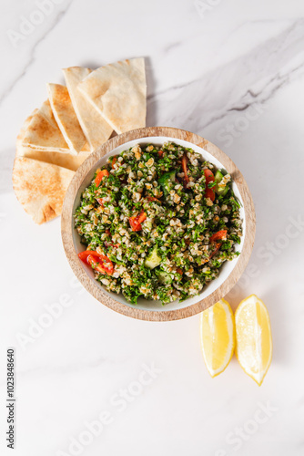 Tabbouleh Salad with Tomatoes, Pita Bread, and Lemon Slices photo