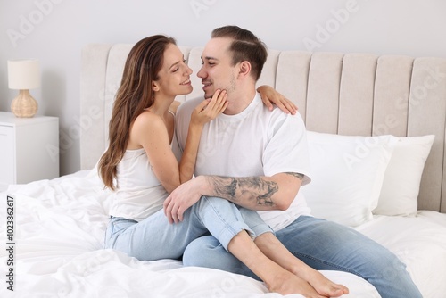 Happy couple spending time together on bed at home