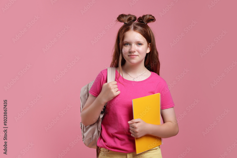 Teenage girl with backpack and notebook on pink background Teenage girl with backpack and notebook on pink background