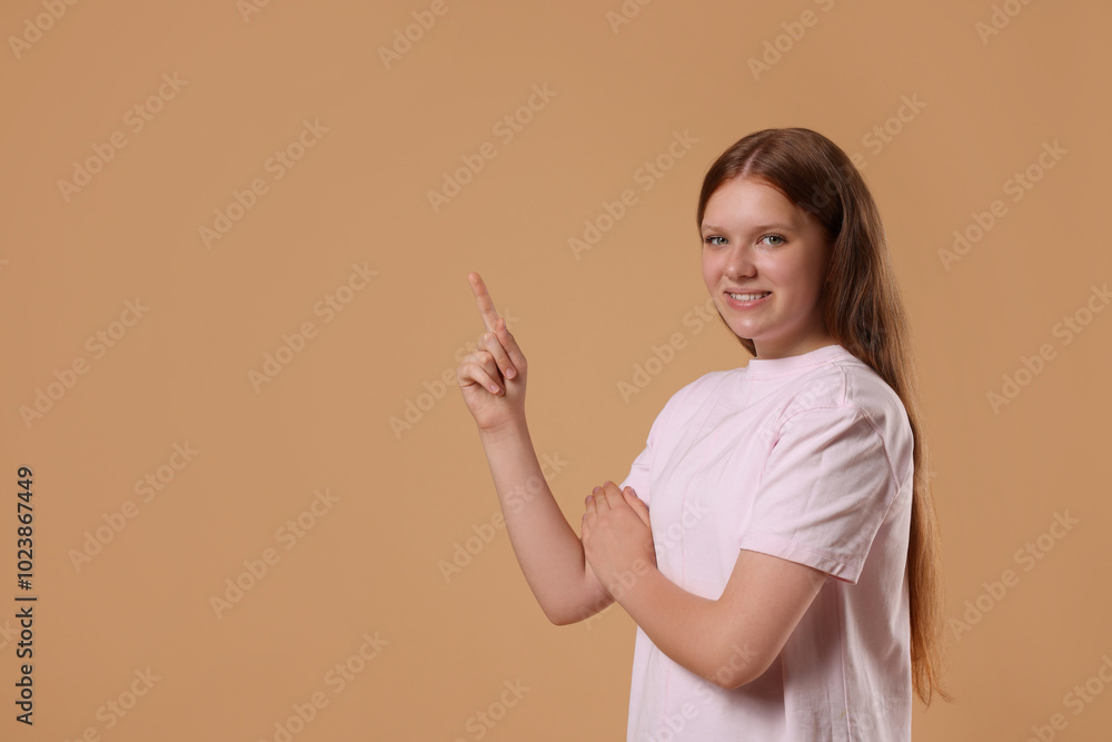 Portrait of teenage girl on beige background, space for text Portrait of teenage girl on beige background, space for text