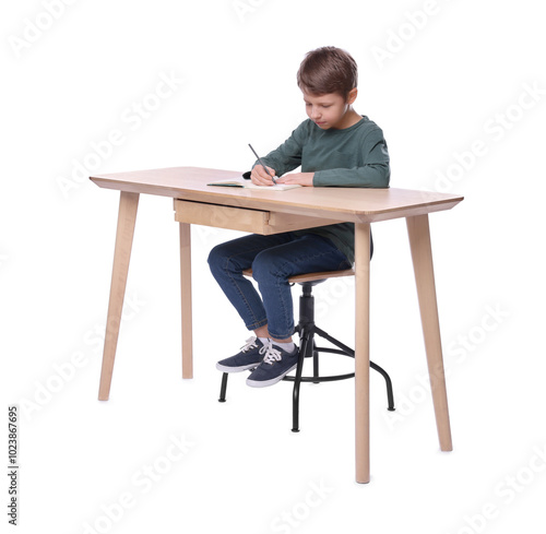 Boy with correct posture and notebook at wooden desk on white background