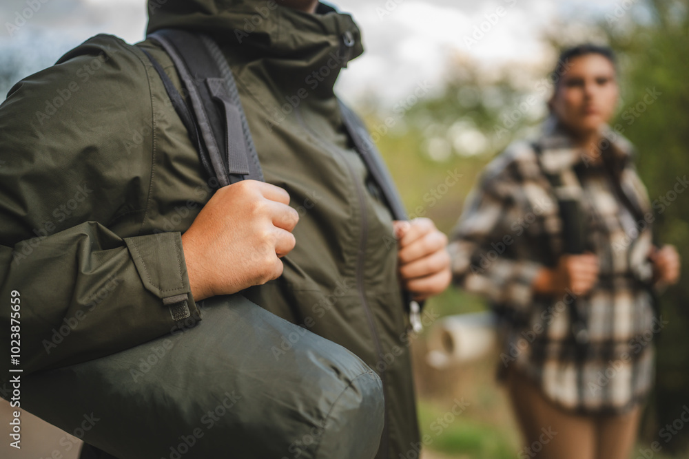 Close up of hikers with backpacks on a nature trail journey Close up of hikers with backpacks on a nature trail journey