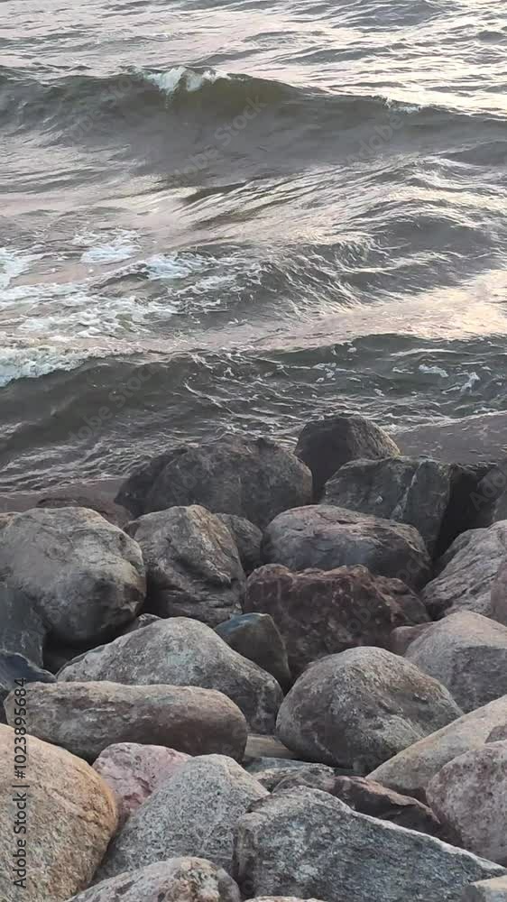 Sea waves splash against the rocks on the coastline. Sea waves splash against the rocks on the coastline.