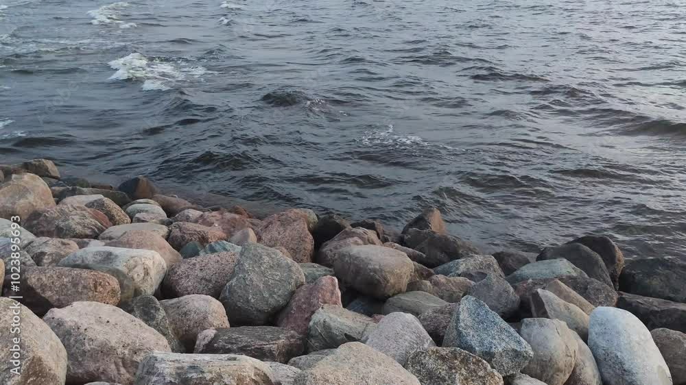 Sea waves splash against the rocks on the coastline. Sea waves splash against the rocks on the coastline.