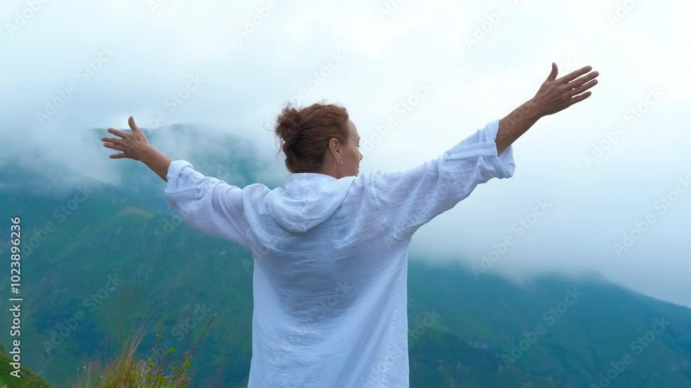 Female with open hands between hills. A joyful female open her hands to meet the green nature of the mountains. A concept of enjoying the mountains place in summer. Female with open hands between hills. A joyful female open her hands to meet the green nature of the mountains. A concept of enjoying the mountains place in summer.