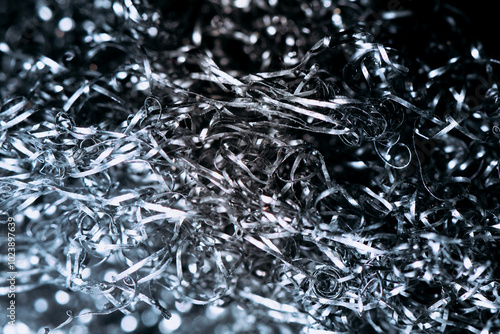 Abstract metal background. Close-up of a tangled mass of metal wire or steel wool. The intriguing and chaotic structure of shiny, silver threads. Complexity, industrail concept.   photo