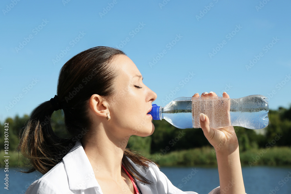 Woman drinking tasty soda water outdoors on sunny day Woman drinking tasty soda water outdoors on sunny day