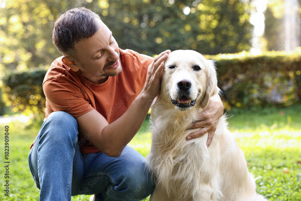 Man with cute Golden Retriever dog on spring day Man with cute Golden Retriever dog on spring day