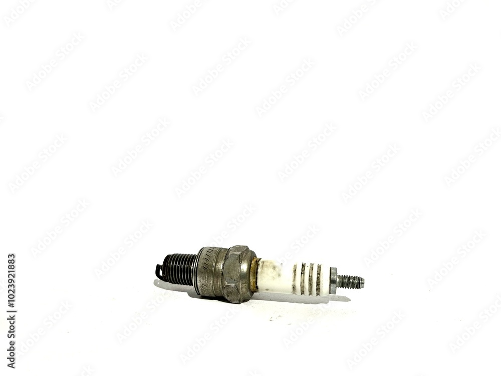 Used and dirty motorcycle spark plug with grease isolated on white background Used and dirty motorcycle spark plug with grease isolated on white background