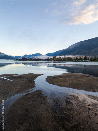 Scenic View of Mountains and Serene Lake in Mission, BC, Canada with Calm Waters Reflecting the Morning Sky