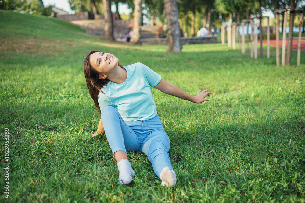Portrait of cute charming lady sitting lend ground fresh green grass enjoy sun nature harmony student resting from city crowd people wear t-shirt jeans colorful park outdoors Portrait of cute charming lady sitting lend ground fresh green grass enjoy sun nature harmony student resting from city crowd people wear t-shirt jeans colorful park outdoors