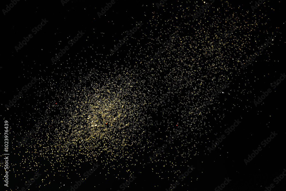 Beautiful shiny golden glitter on black background, top view Beautiful shiny golden glitter on black background, top view