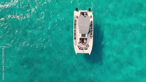 Catamaran with tourists and crew is sailing slowly on turquoise water in mexico, captured in slow motion