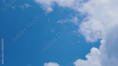 Bright blue sky with fluffy white clouds on a clear sunny day