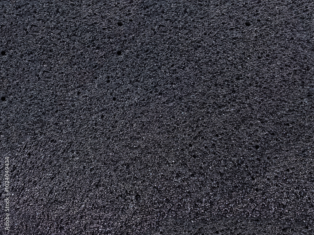 Fototapeta premium black sponge foam material surface background. textured absorbent material and coarse pores