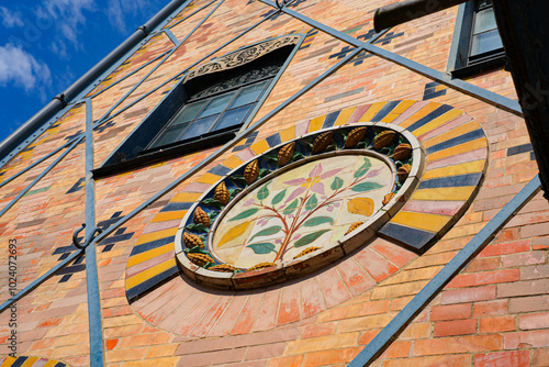 Tiled cocoa flower on the facade of the Saulnier watermill in the former Menier Chocolate Factory in Noisiel, Paris Region, France photo