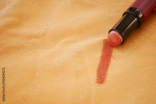 Lipstick stain on yellow cloth 