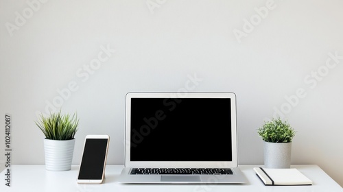 Minimalist Workspace with Laptop, Smartphone, and Plants